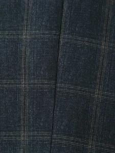 Close-up detail showing the vintage navy and brown plaid fabric texture of the jacket