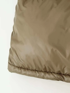 Detailed close-up showing the premium stitching and texture of the olive green padded jacket