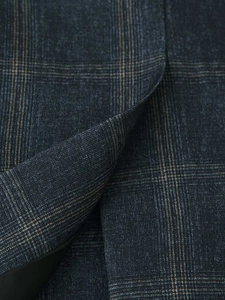 Macro shot of navy blue and tan plaid fabric texture for vintage blazer jacket