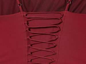 Macro detail of sexy lace-up criss-cross back design on deep red satin dress