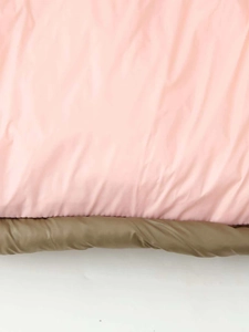 Detail view of quilted olive green and pink puffer jacket fabric with high density stitching