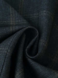 Macro shot of dark grey plaid fabric texture with subtle brown windowpane pattern