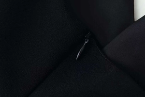 Detailed view of seamless invisible zipper closure on black textured fabric