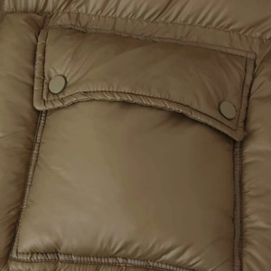 Olive green and pink puffer jacket featuring detailed snap button pocket and quilted fabric
