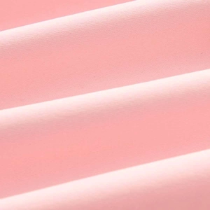 Close-up of pink textile fabric showing fine knit texture and soft drapery folds