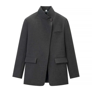 Detail of the high-quality grey plaid fabric and asymmetric single button on the stand collar blazer