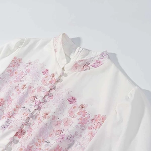 Detail of mandarin collar with pink floral pattern and traditional frog button