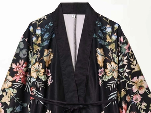 Detailed view of black satin kimono with floral print, tie-waist and size S tag