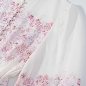 Detailed view of the elegant pink floral print and delicate buttons on the summer dress
