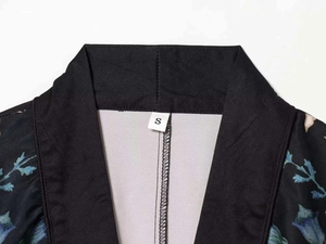 Detail of floral printed satin kimono neckline with brand label in size S