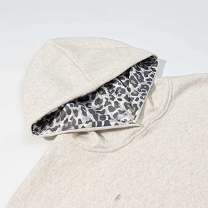 Detail of the leopard print hood lining on this light grey loose-fit casual hoodie
