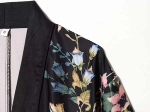 Close-up of floral print satin kimono pajama top with stitched size label detail