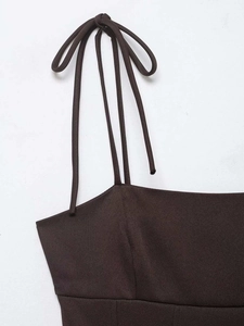 Detail of slim tie-up shoulder straps with bow knots on a brown ribbed fabric top