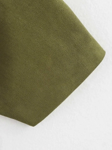 Detailed close-up of olive green suede bomber jacket cuff with ribbed knit texture
