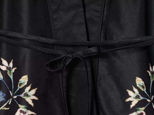 Detail of floral print and waist tie on black satin kimono style sleepwear set