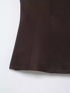 Detail of dark brown stretch top showing high-quality twill texture and fine stitching