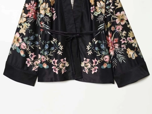 Detail view of floral print satin kimono pajama set with silky texture and tie waist