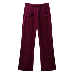 Detail view of burgundy velvet wide-leg trousers featuring elastic waist and rear pockets