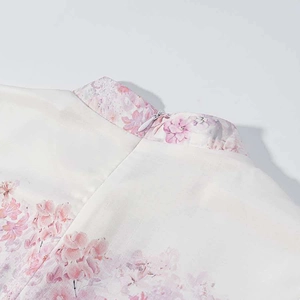 Detail of pink floral print dress showing the stand collar and back invisible zipper