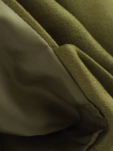 Close-up of olive green bomber jacket showing suede texture and smooth inner lining