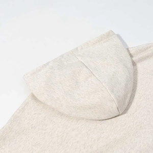 Detailed macro view of the heather grey knit fabric and stitching on a leopard hoodie