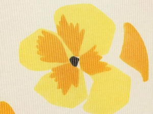 Detail of vibrant yellow and orange floral 3D digital print on white dress fabric