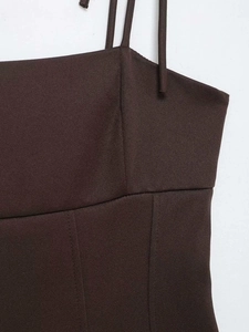 Detail of dark brown elastic top featuring fine textured fabric and neat structural stitching