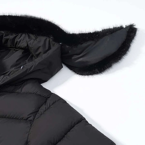 Detail view of black quilted parka with fur trim hood and playful rabbit ear design