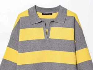 Close-up of the knit polo collar and V-neckline on this yellow and gray striped sweater