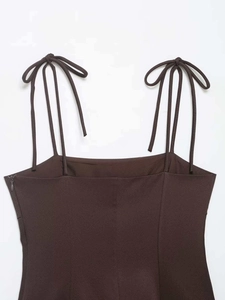 Detailed macro view of dark brown elastic top with slim straps and invisible side zipper