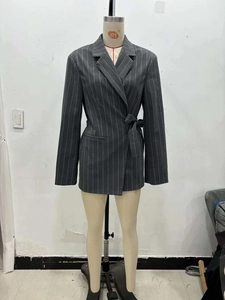 Detail of grey pinstripe blazer with waist tie and peak lapels for women office wear