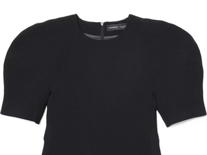Detail of black dress with puff sleeves, round neck, and metal back zipper closure