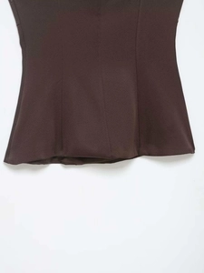 Close-up of chocolate brown stretch fabric with vertical stitching and neat hem detail