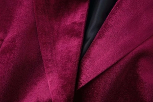 Detail view of burgundy velvet blazer collar with notch lapel and premium inner lining