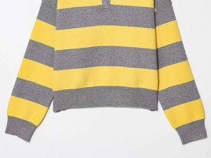 Detail of V-neck polo collar and rib-knit cuffs on a yellow and gray striped sweater
