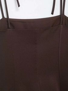 Close-up of brown bow-tie elastic top featuring fine twill fabric and thin straps