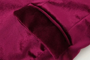 Detailed macro view of pocket flap on wine red velvet blazer with clean stitching