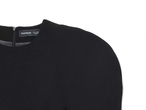 Detail of round neckline with metal zipper and puff sleeve on black dress