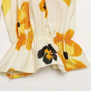 Women's long sleeve dress with sunflower print and elastic ruffled cuff detail