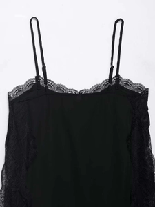 Close-up of black lace-trimmed camisole with adjustable straps and matte fabric detail