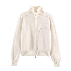 Detailed view of cream knit cardigan with dual zipper and ribbed collar texture