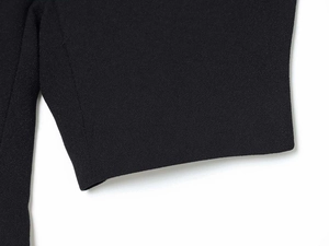 Close-up of minimalist black fabric texture and clean stitching on puff sleeve cuff