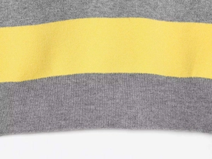 Detailed macro view of grey and yellow striped fine knit fabric with ribbed hem