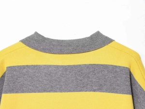 Macro shot of striped knit sweater collar with precise yellow and grey woven patterns