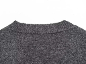Detailed close-up of dark grey knit texture and high-quality neckline stitching