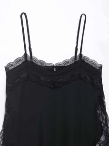 Close-up of black lace-spliced camisole top featuring delicate floral embroidery details