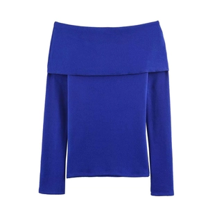 Detail of royal blue off-shoulder sweater with folded neckline and slim knit texture