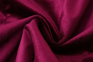 Macro detail of deep wine red velvet fabric showing smooth texture and soft luster