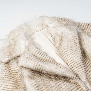 Detailed macro view of apricot striped faux fur coat collar with soft satin lining