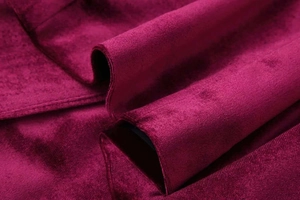 Macro detail of wine red velvet fabric showing soft texture and premium glossy finish